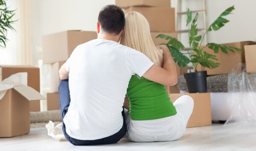 A couple sitting on the floor