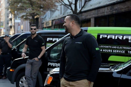 men standing beside Paragon cars