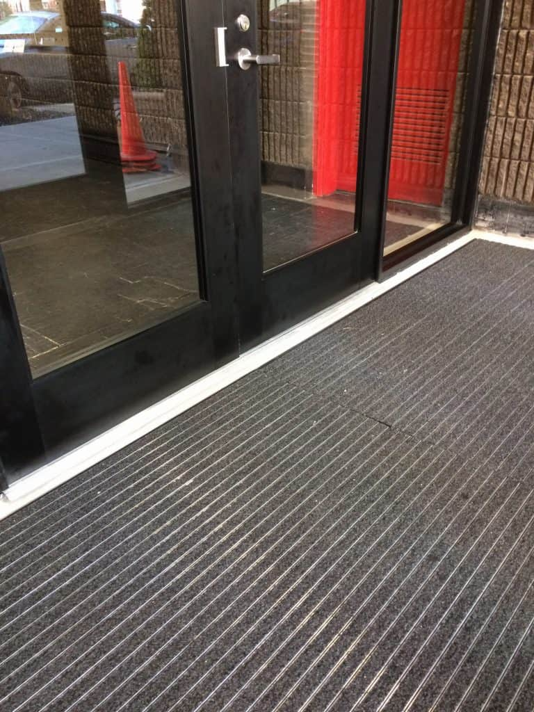 Bottom of Aluminum frame heavy gauge doors with interior carpet Photo