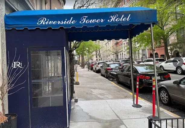 Riverside Tower Hotel entrance with blue awning on a New York City street